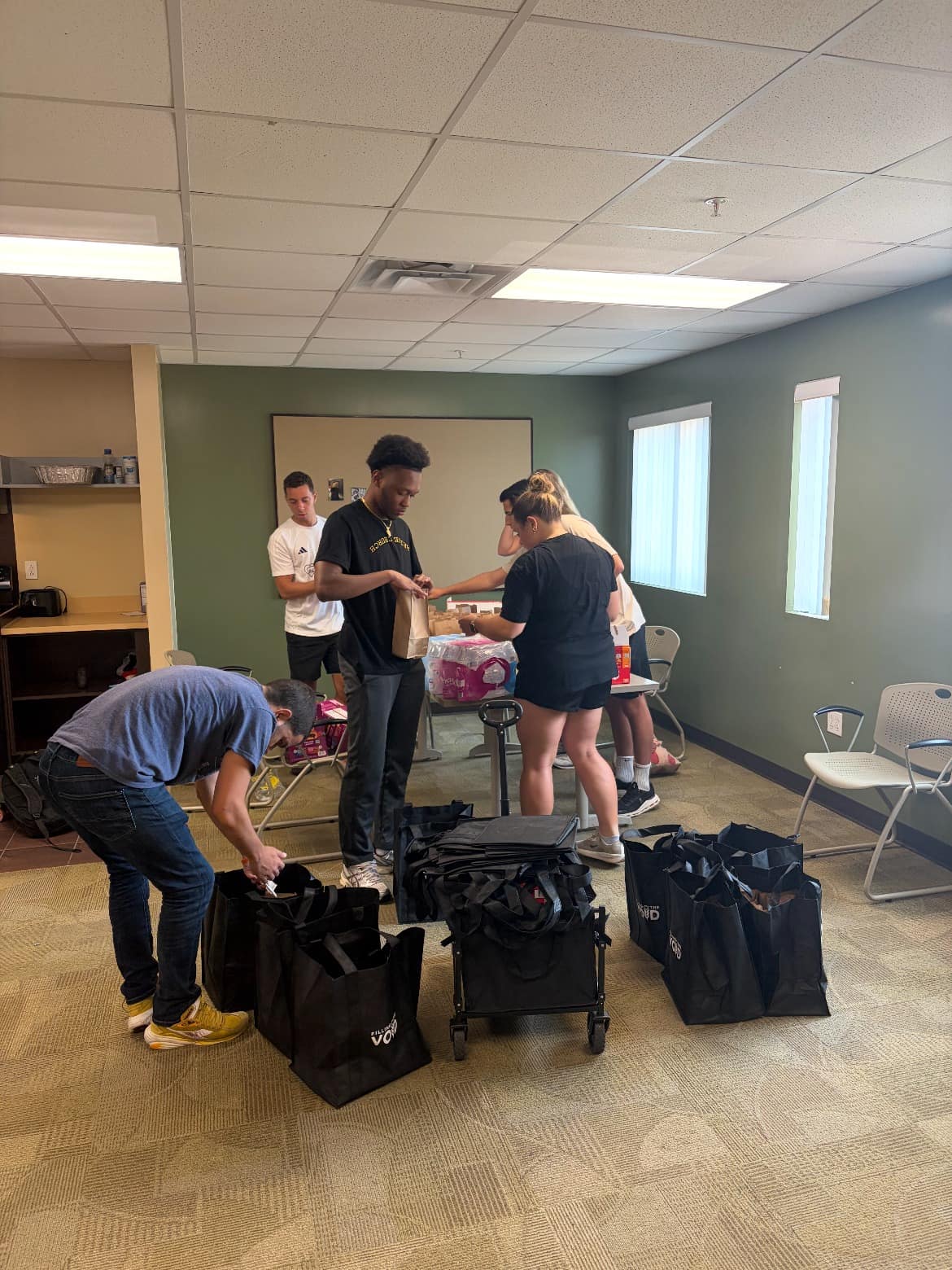 Making Heaven Crowded volunteers preparing outreach bags before serving in downtown Tampa