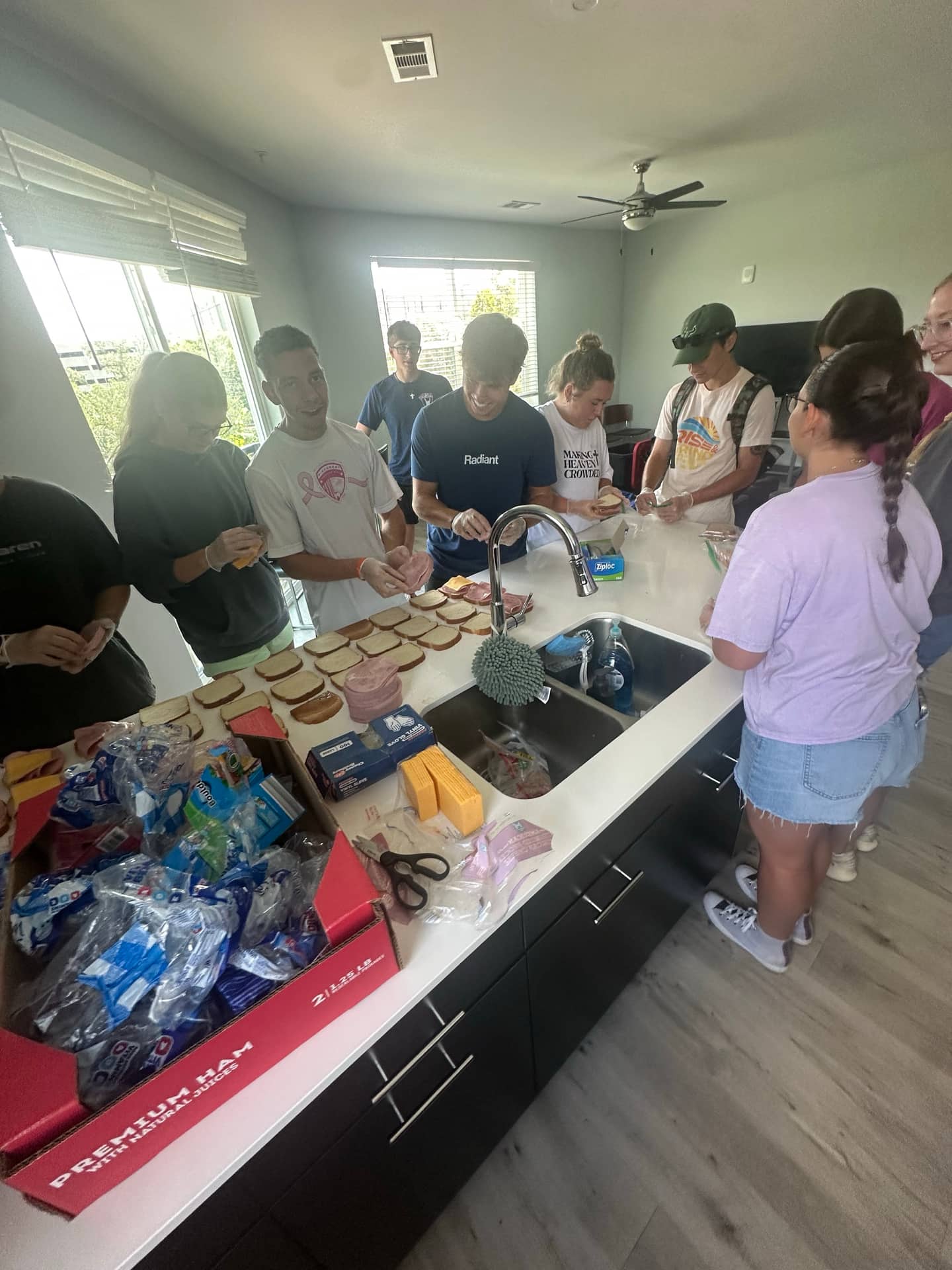 Volunteers packing rows of sandwiches that outreach teams hand out in Tampa and Gainesville