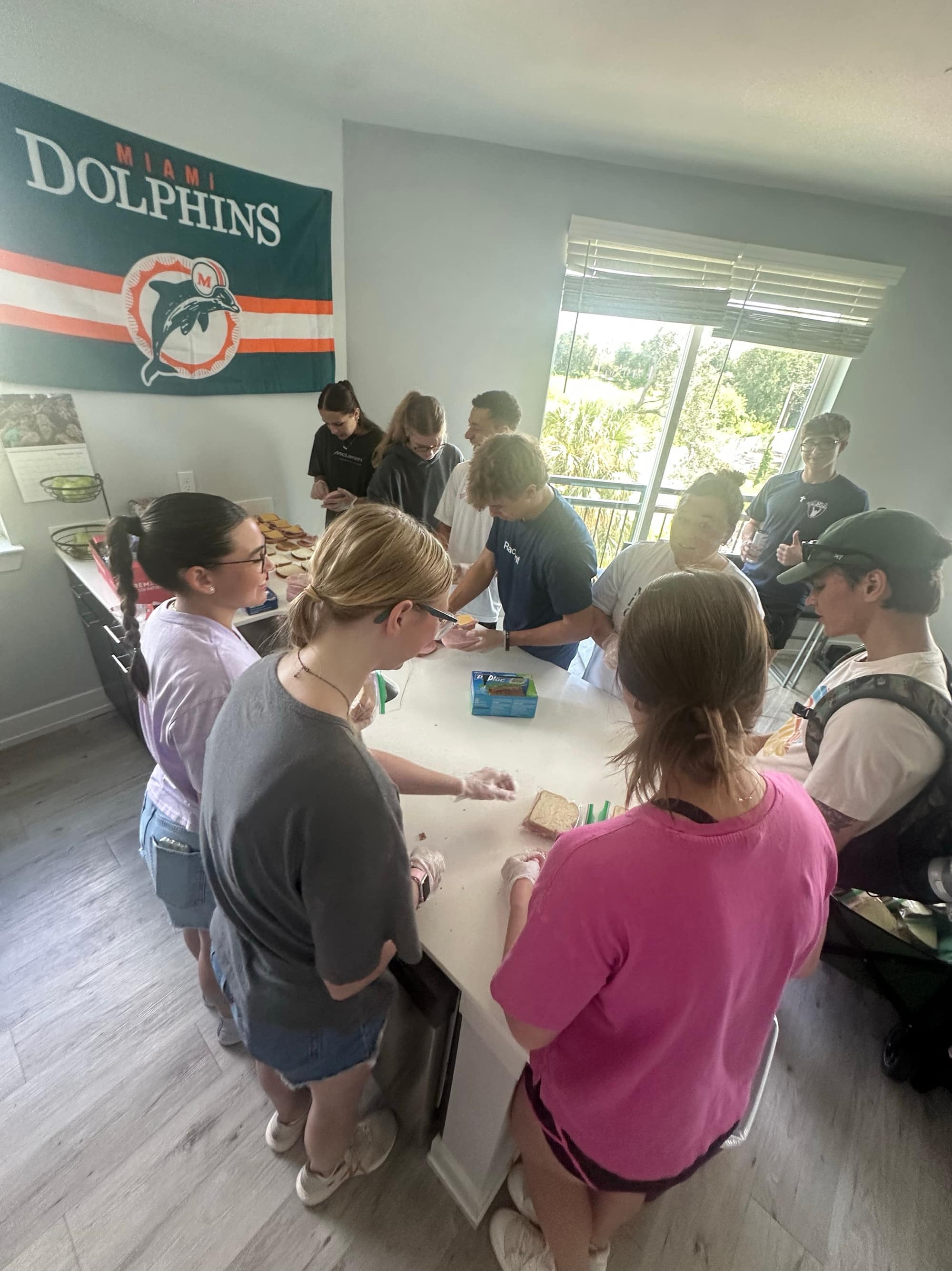 Volunteers gathered around a kitchen counter preparing food before an outreach