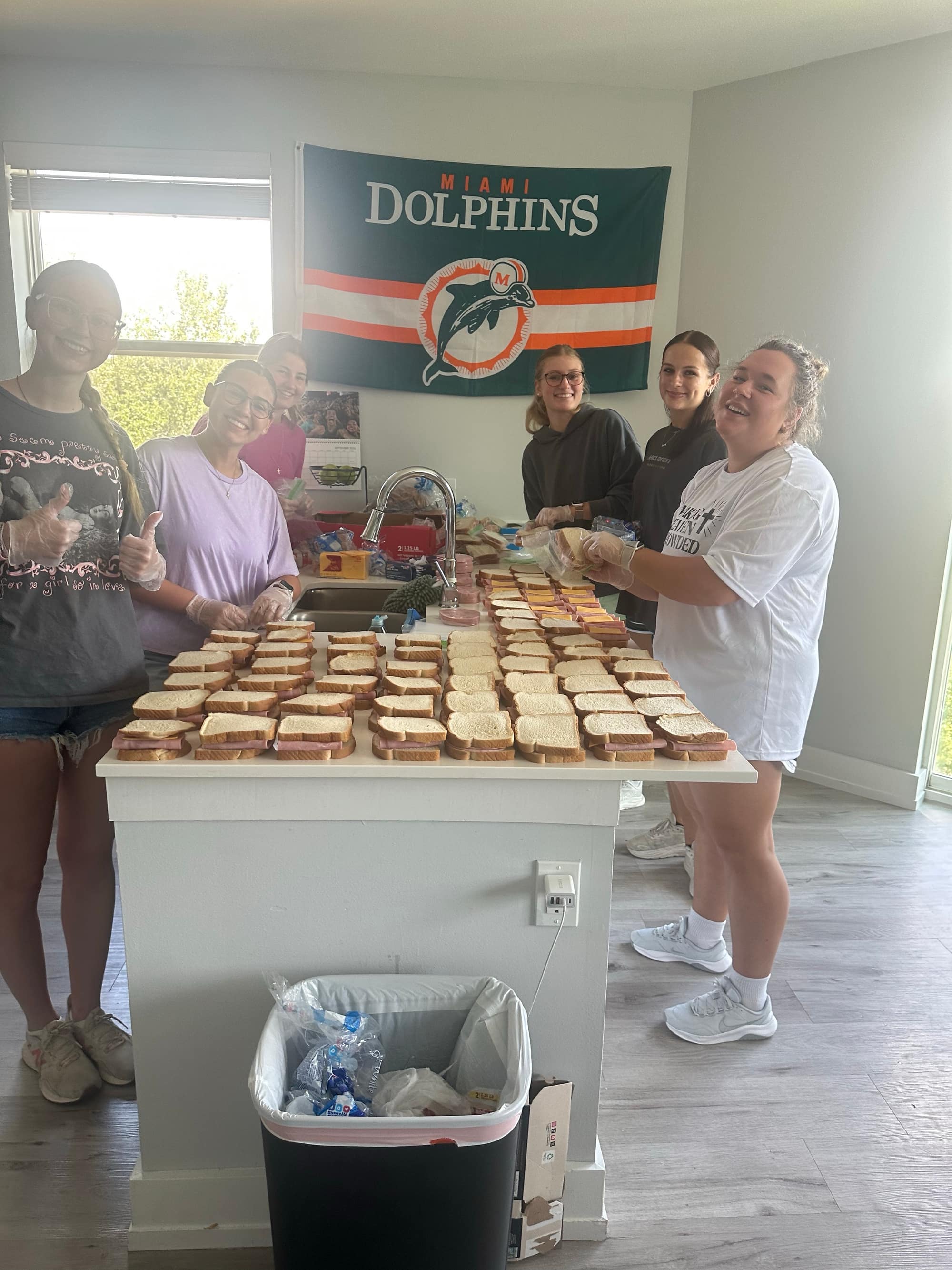 Volunteers packing rows of sandwiches that outreach teams hand out in Tampa and Gainesville